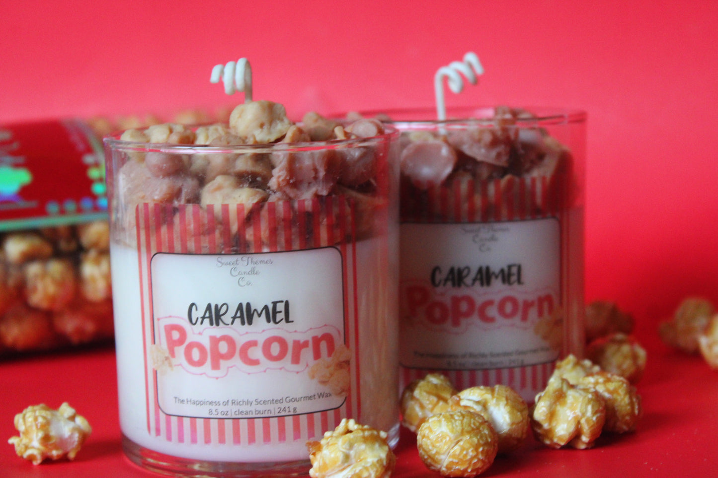 Two containers of caramel popcorn with visible labels on a red background