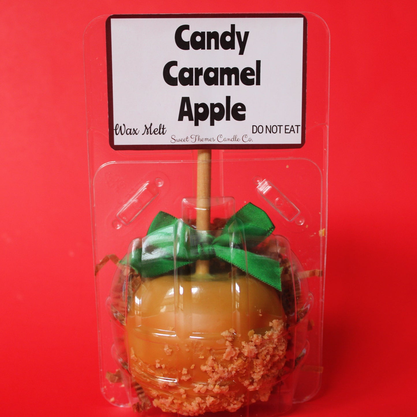 Candy Caramel Apple wax melt in packaging with a red background