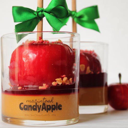 Candy apple in a glass with a green bow, labeled 'Macintosh Candy Apple'.